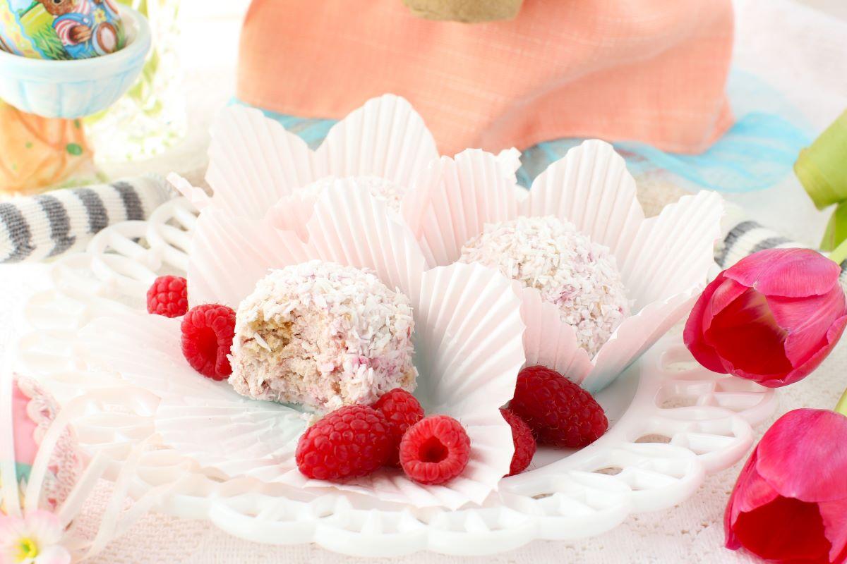 a platter of white chocolate raspberry snowballs on a festive table setting