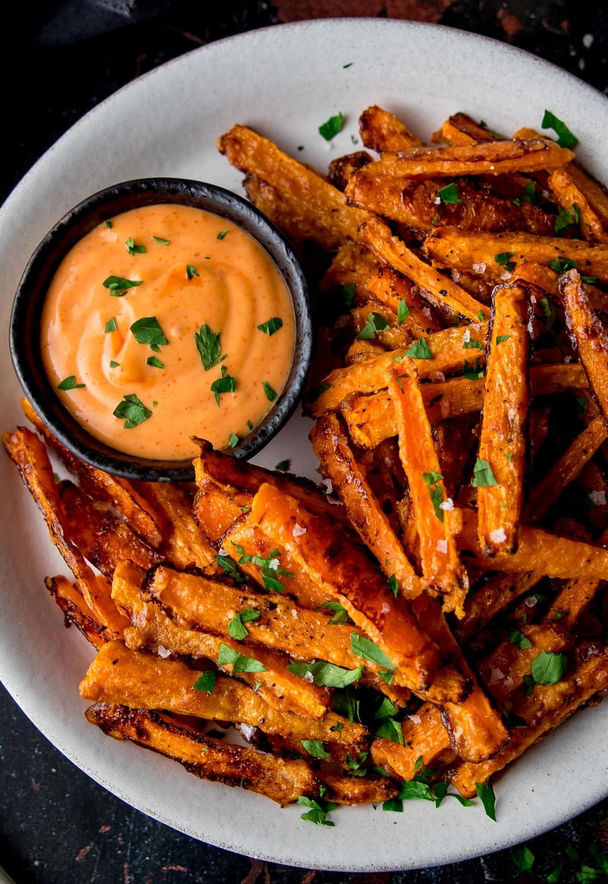 close up shot of carrot fries served with avocado ranch dressing