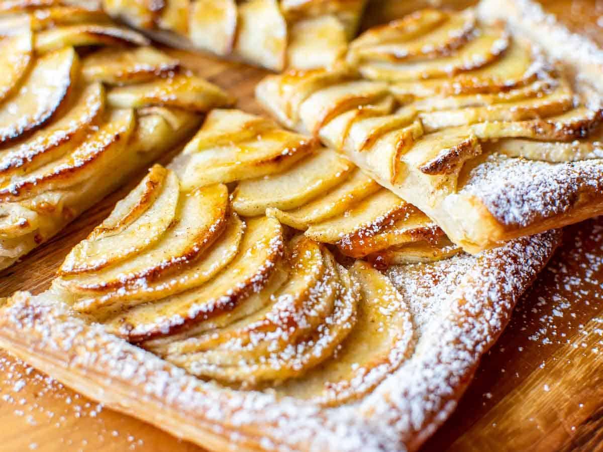 close-up of apple slices being arranged on tart dough