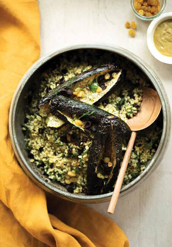 Zucchini and bulgur bake with various herbs and spices sprinkled on top