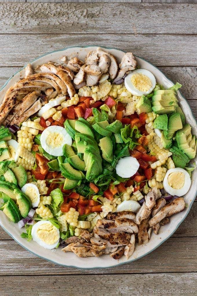 ingredients for chicken and avocado salad laid out on a kitchen counter