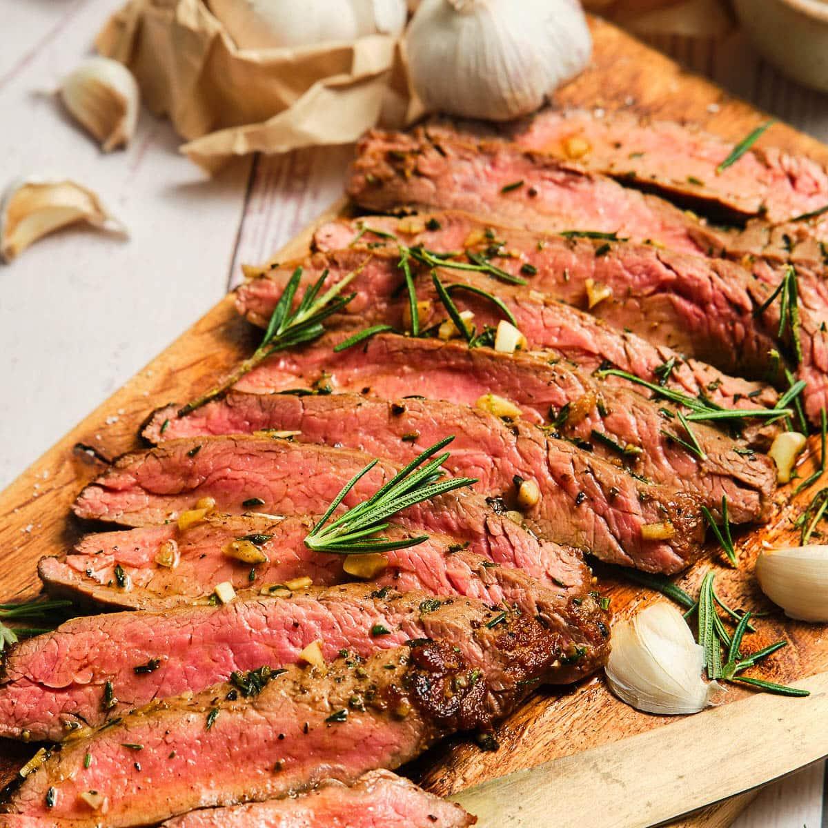 sliced flank steak with tarragon garnish