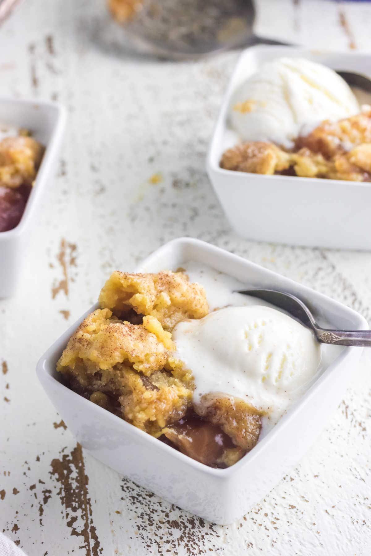 caramel apple dump cake cooked in a slow cooker over a campfire