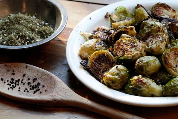 golden brown roasted brussels sprouts with za'atar and olive oil plated and ready to serve