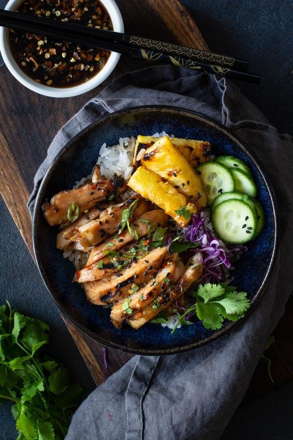 close up of chicken marinating in coconut milk with pineapple chunks