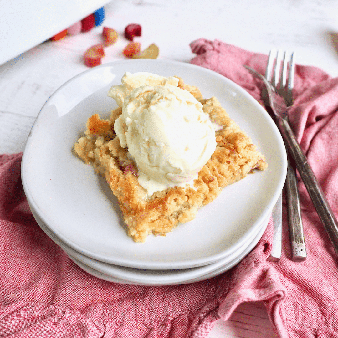 angelic rhubarb dump cake with a scoop of vanilla ice cream