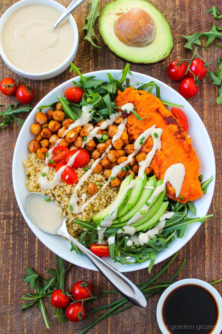 quinoa bowl with roasted sweet potatoes, avocado, and cilantro, bright summer lighting