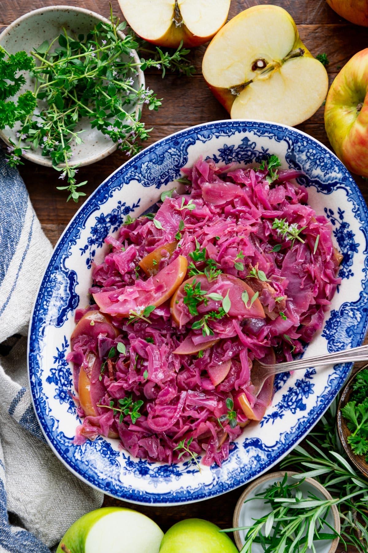 Warm cozy kitchen with a bowl of braised red cabbage on a wooden table, soft focus