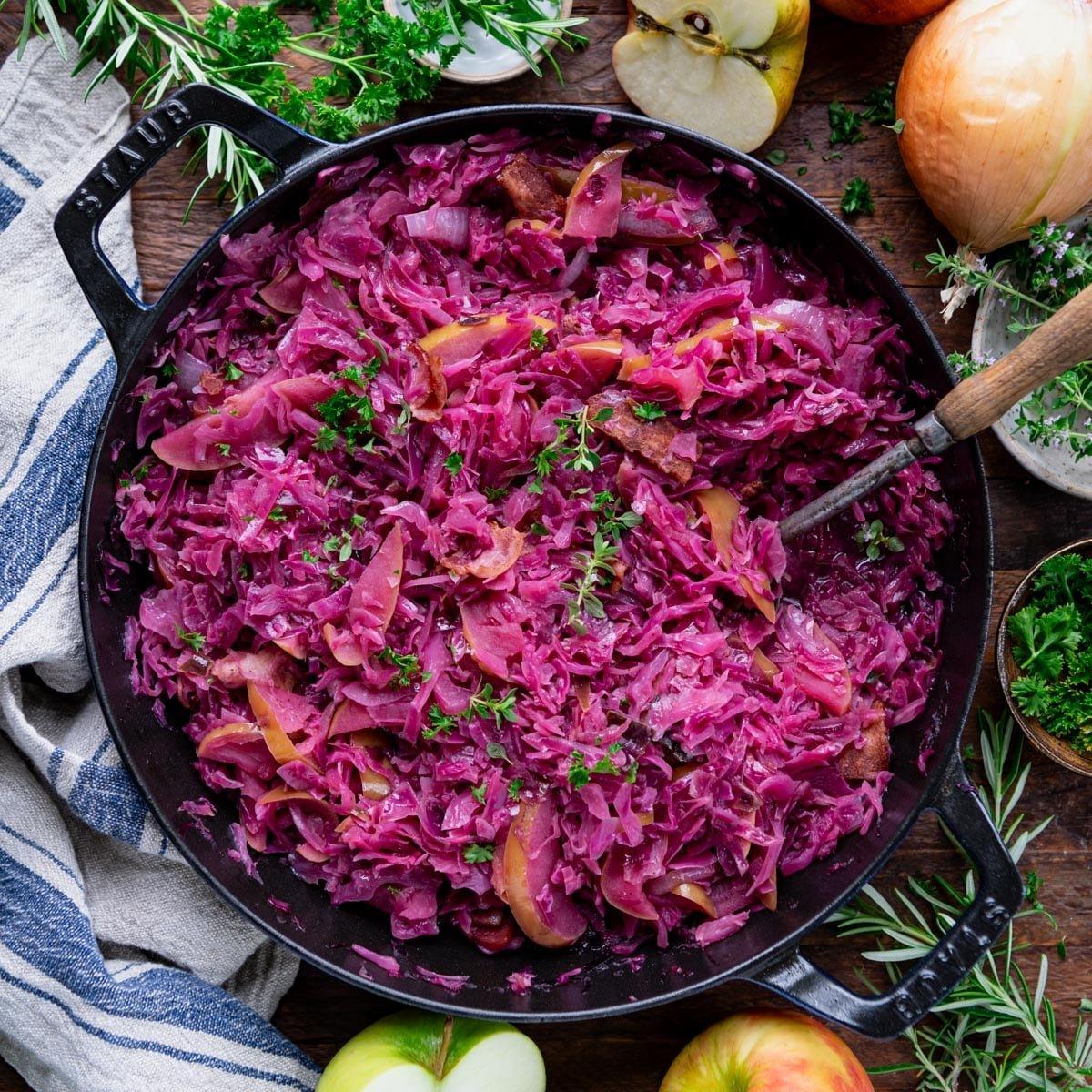 Vibrant braised red cabbage with apples and spices in a dutch oven