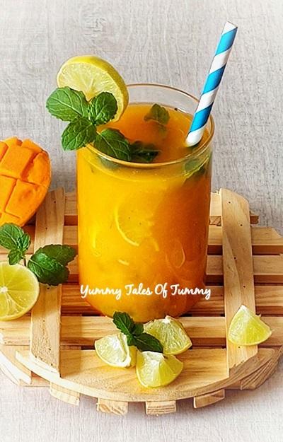 Ingredients for Marjoram Mango Virgin Mojito arranged on a wooden table