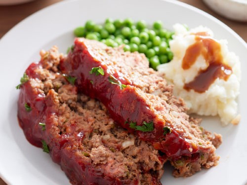 homemade southern meatloaf on a plate with mashed potatoes and gravy