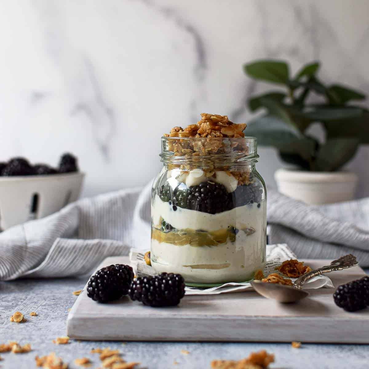 layered loganberry lemon curd parfait in a glass