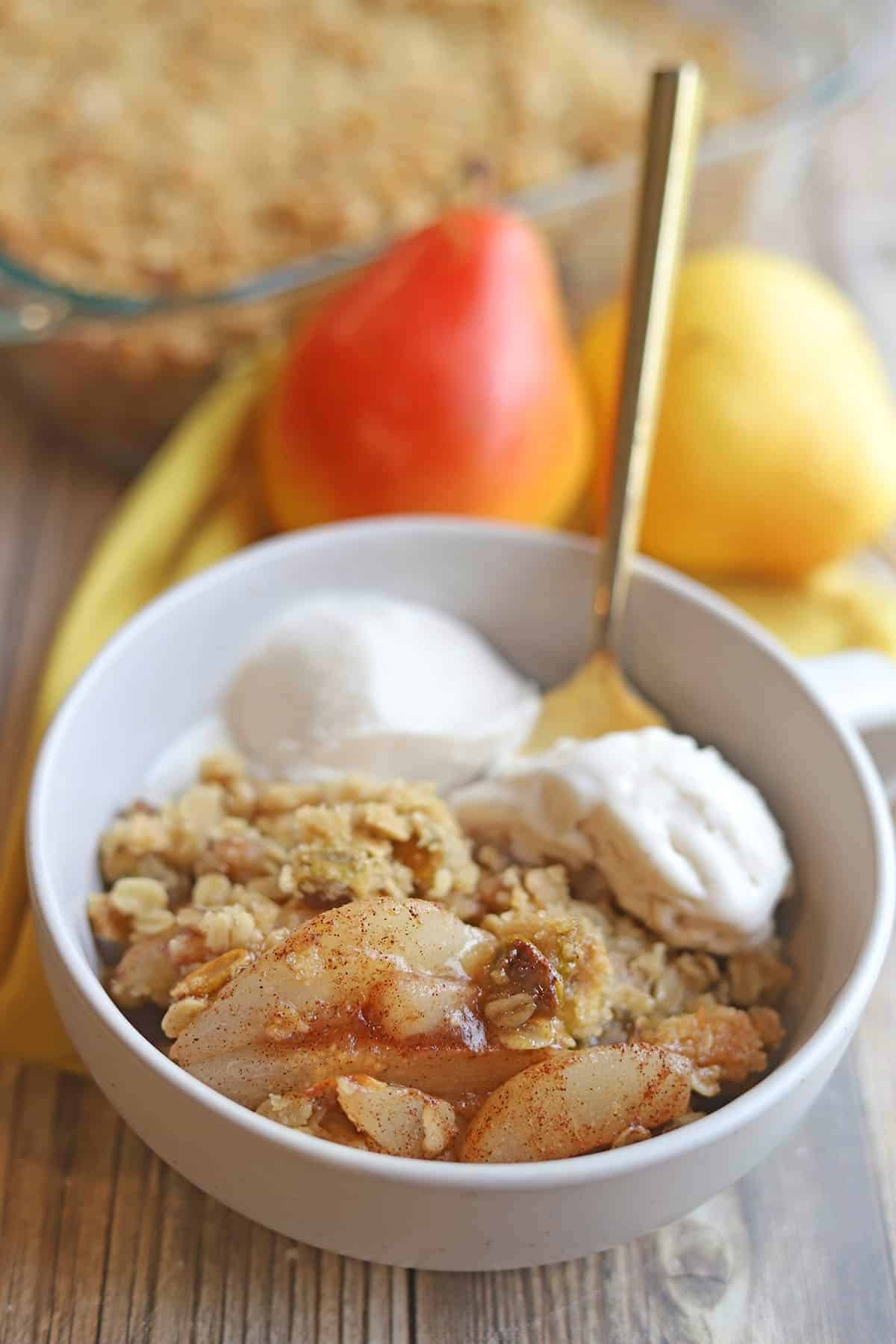 warm pear crisp with creamy custard in a rustic setting