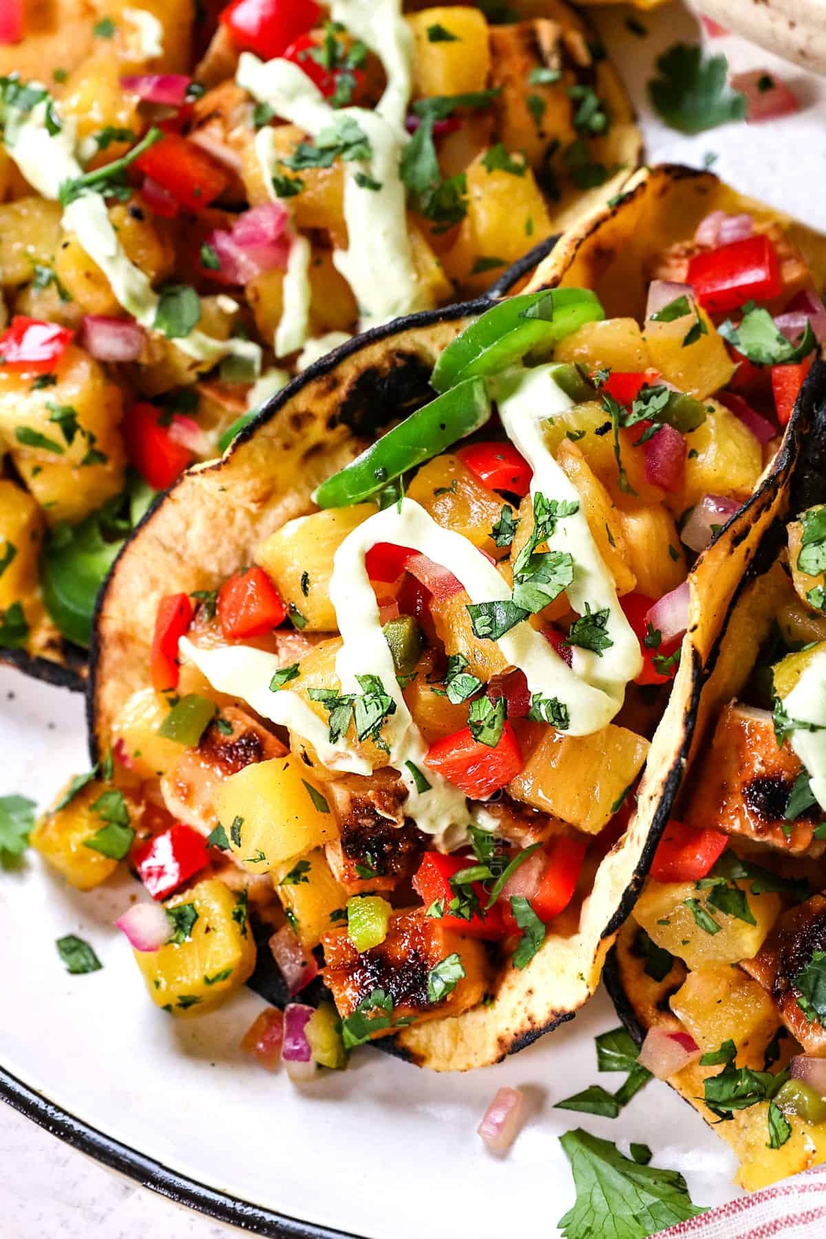 vibrant close-up of pineapple chicken tacos with fresh salsa and lime