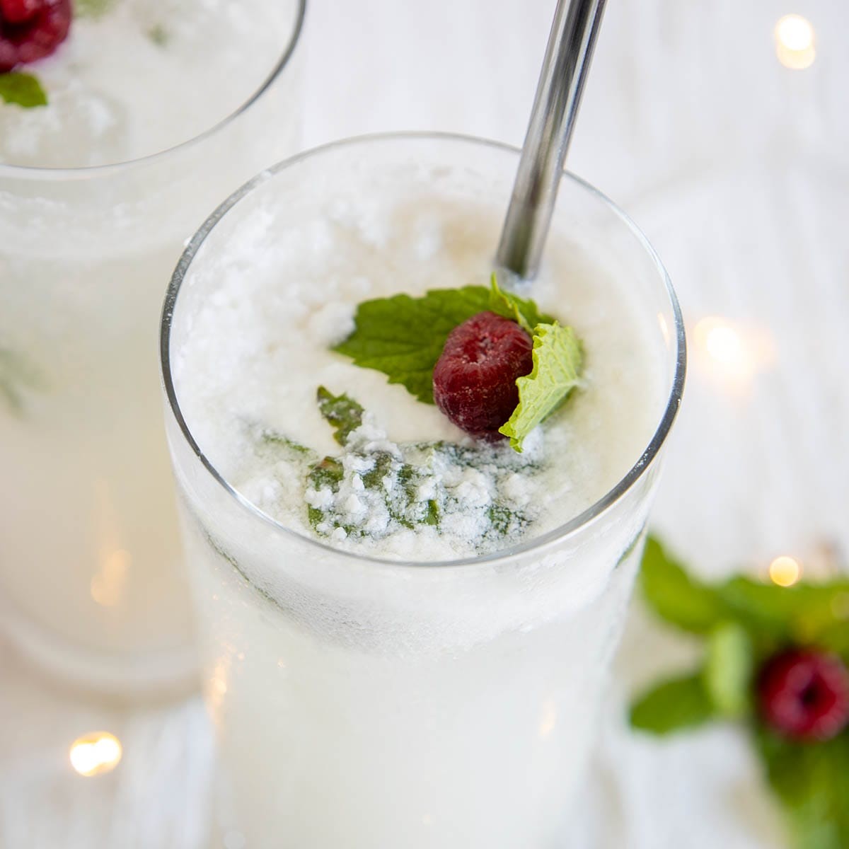Festive coconut mojito with holiday decorations, tropical background, and snow elements