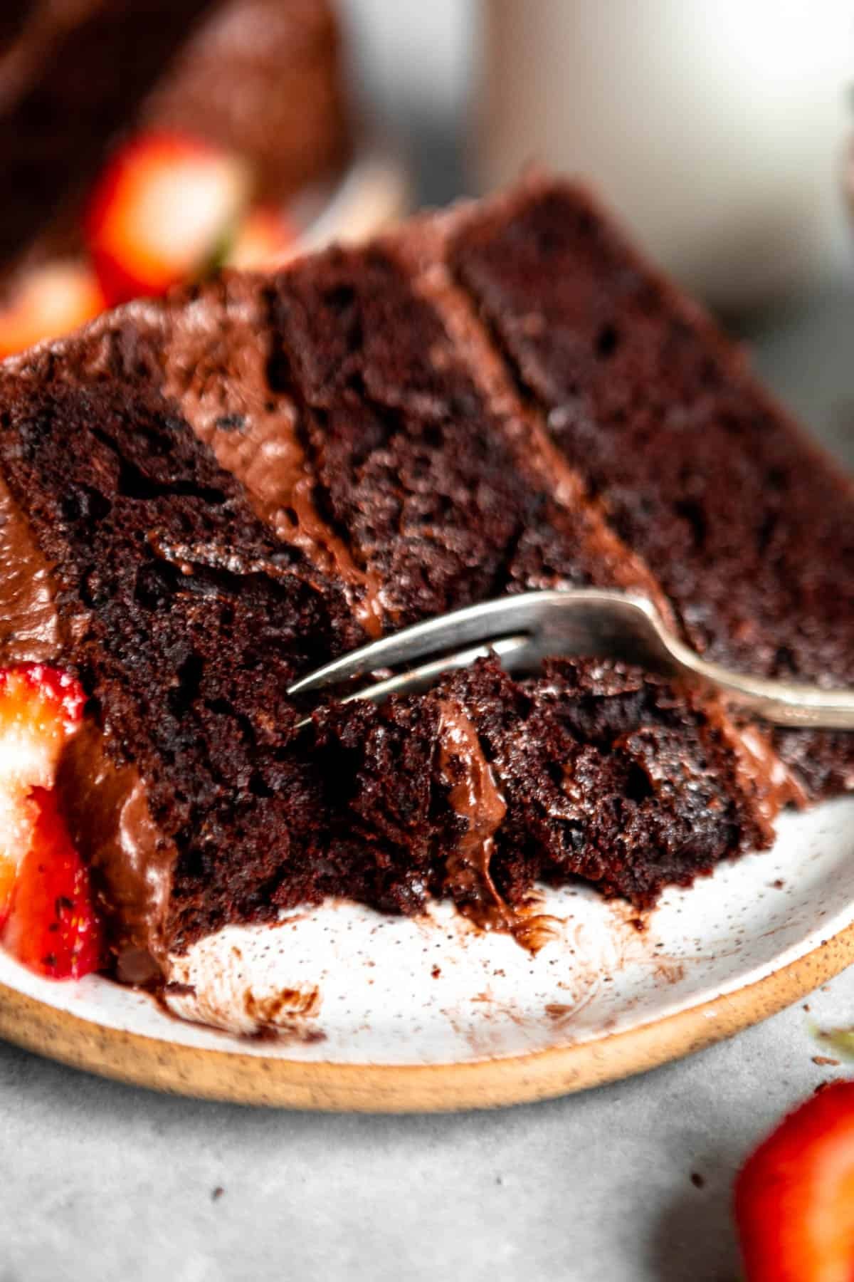 moist almond flour chocolate cake slice, close up, dark background
