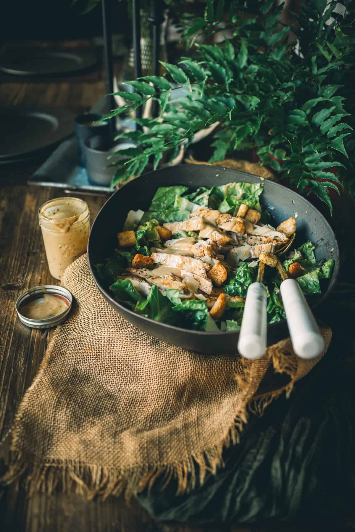 Kale Caesar Chicken Parmesan on a rustic wooden table