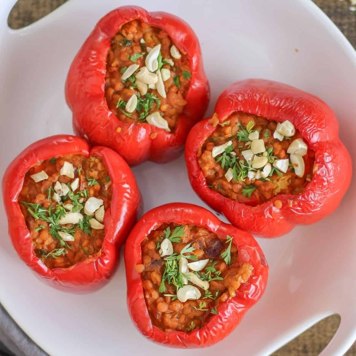 Indian spiced lentils stuffed inside colorful bell peppers topped with coconut milk