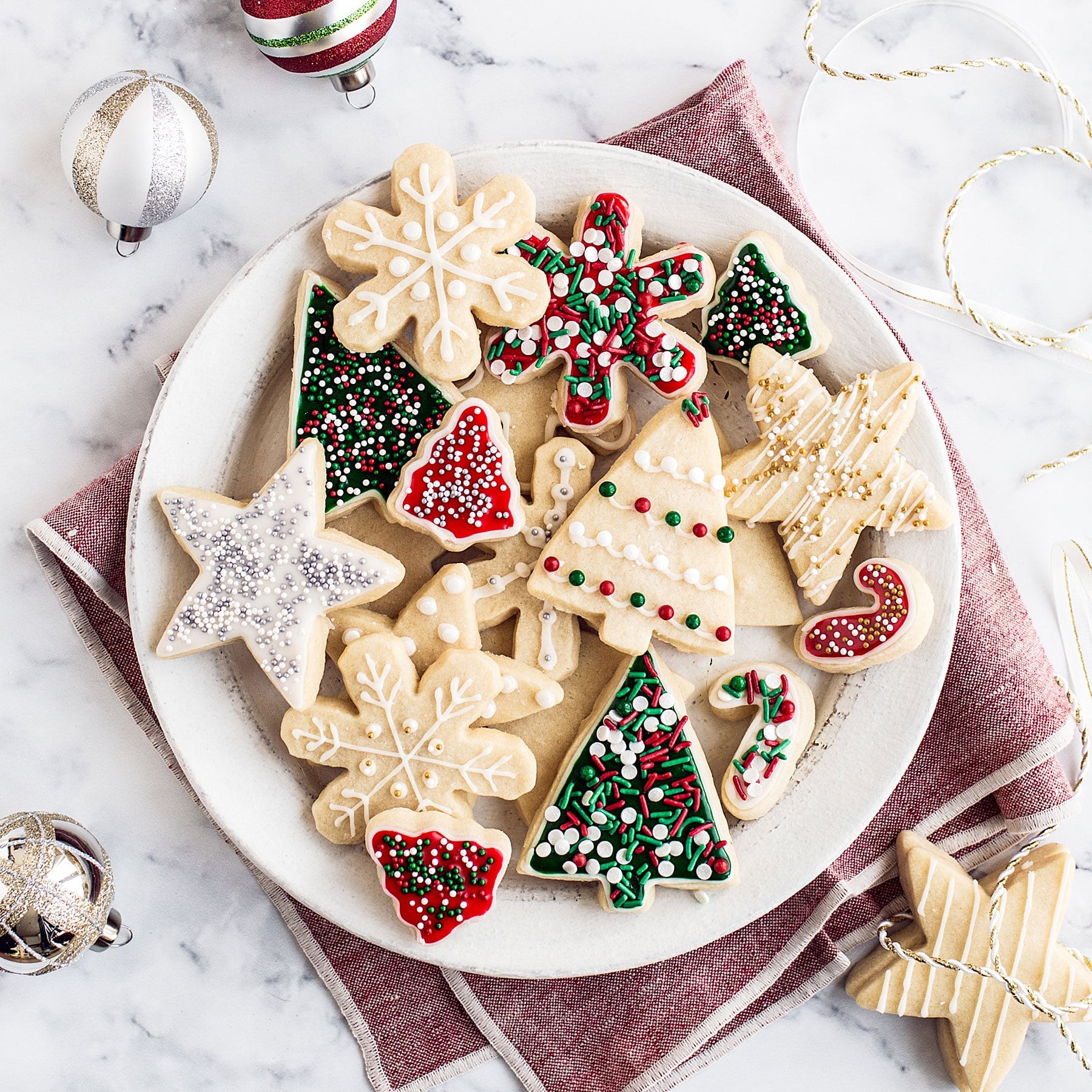 Christmas French tip sugar cookies arranged elegantly on a festive platter with holiday decor