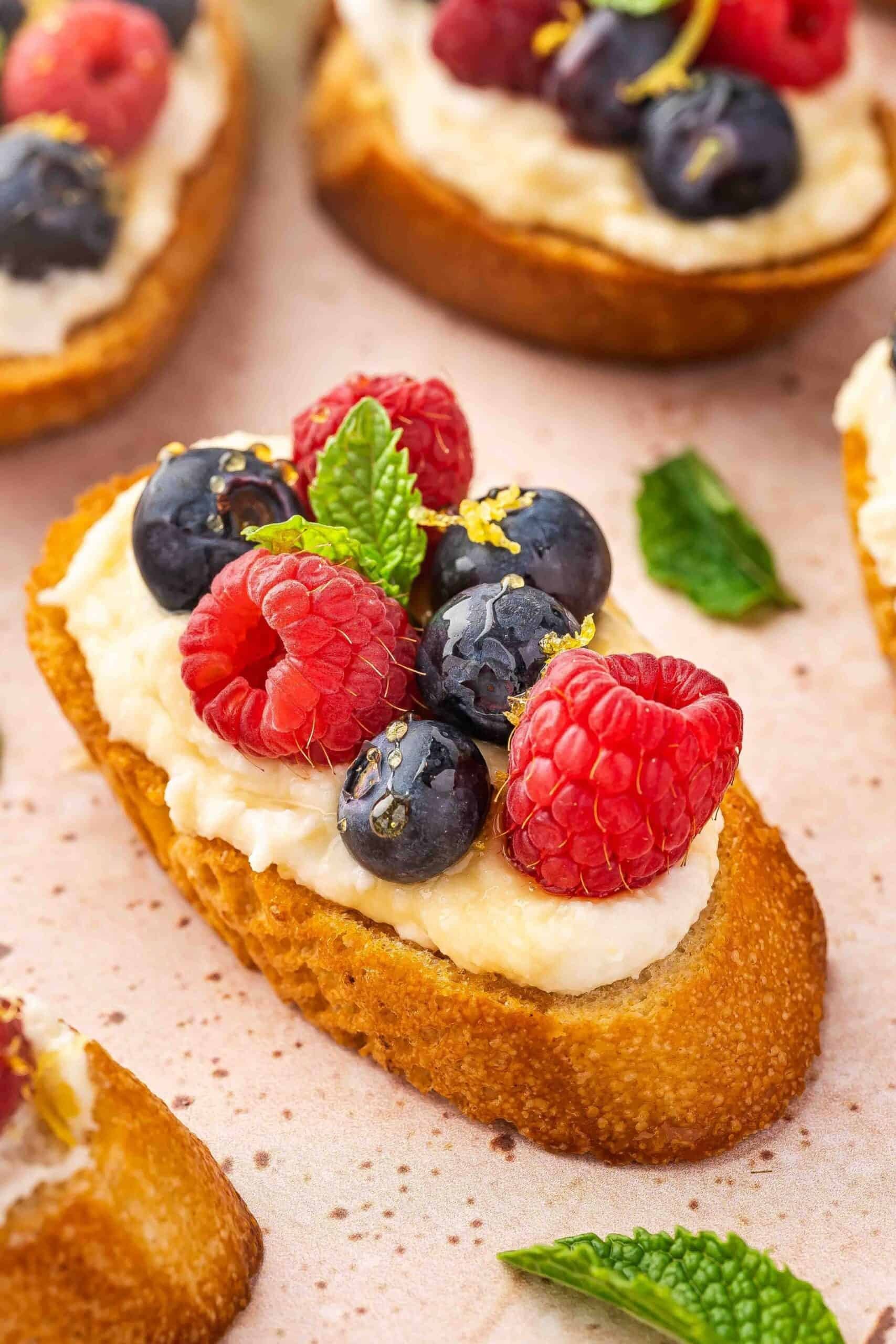 Berry bruschetta with ricotta cheese and honey drizzle