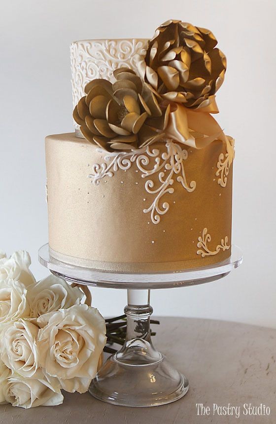 A beautifully decorated layer cake with gold accents