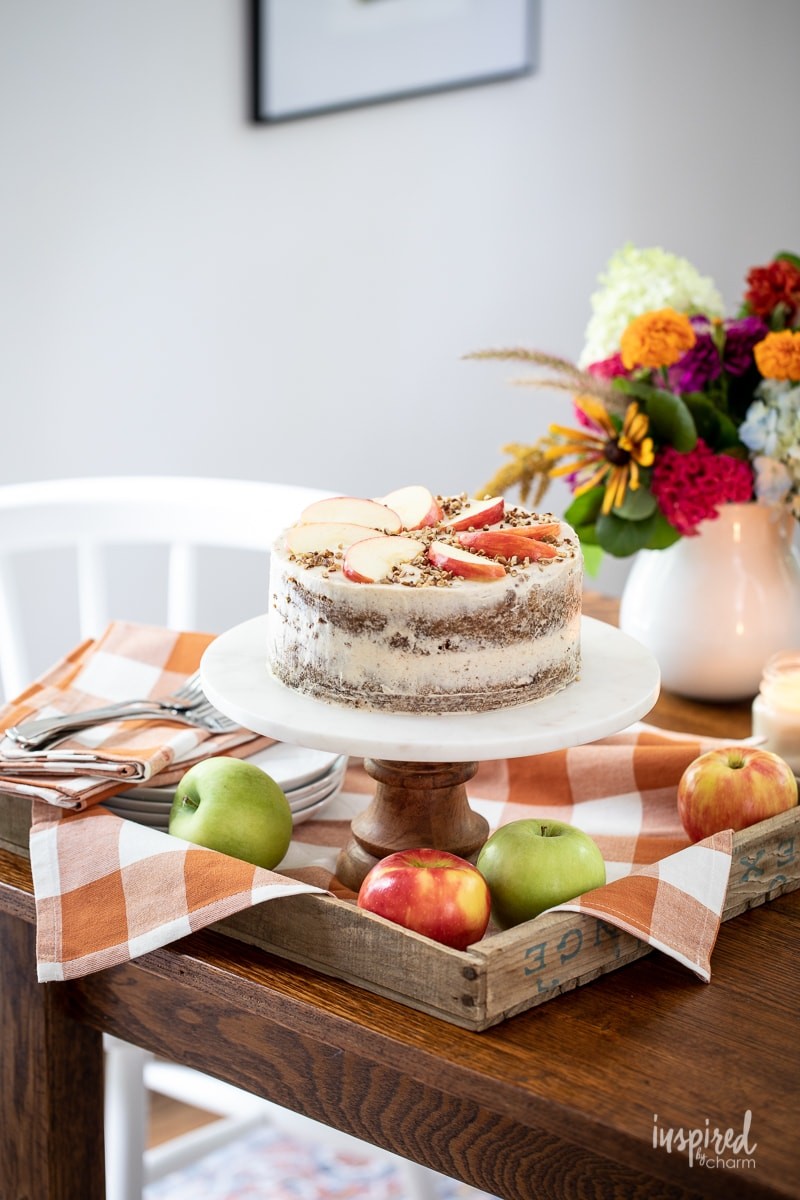 cinnamon apple cake on a wooden table with fall decorations