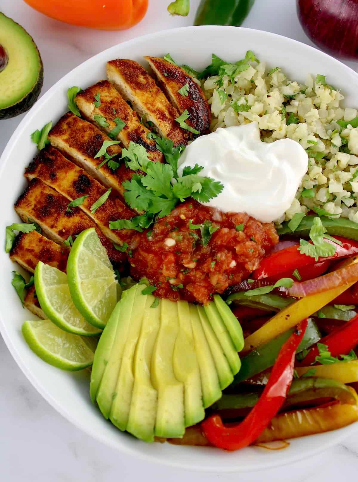 Keto chicken fajita bowl with avocado and cilantro