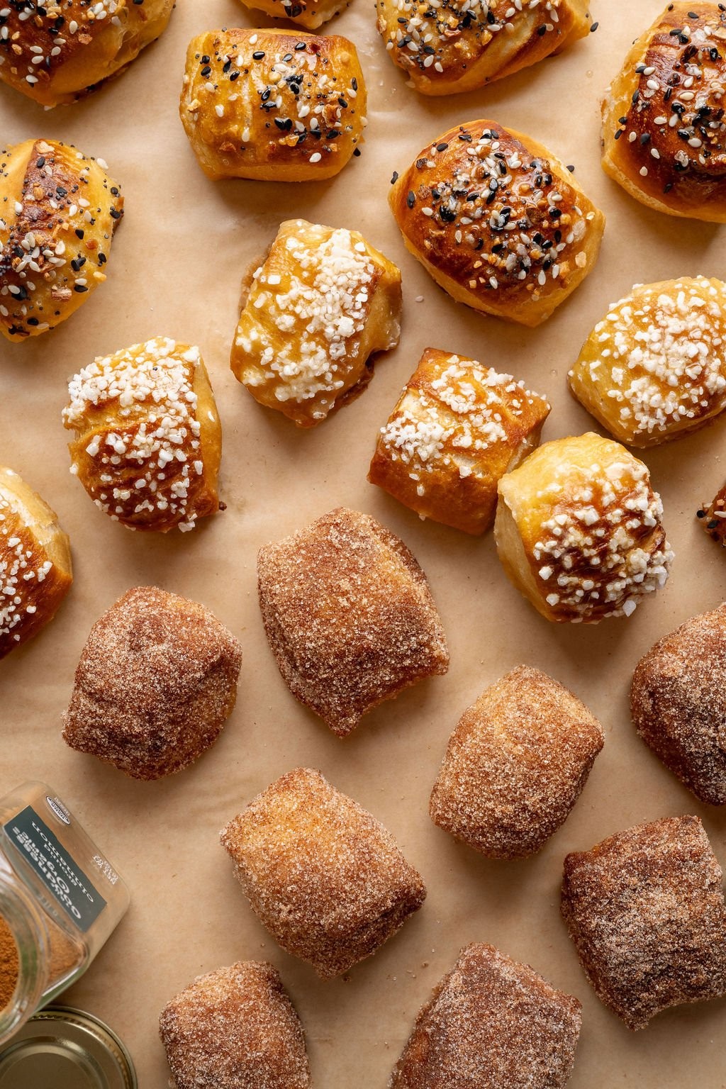 Golden brown salt dough pretzel bites on a parchment-lined baking sheet, close-up