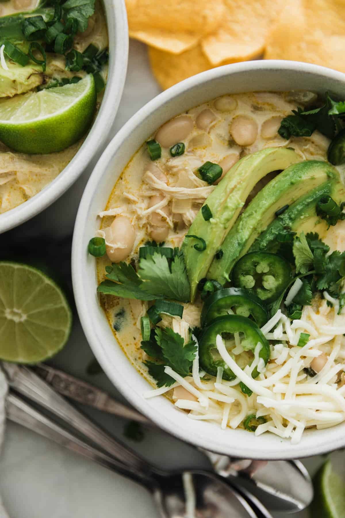 bowl of creamy white chicken chili garnished with cilantro