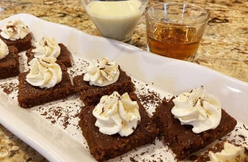 eggnog brownies with a dusting of nutmeg and a glass of eggnog