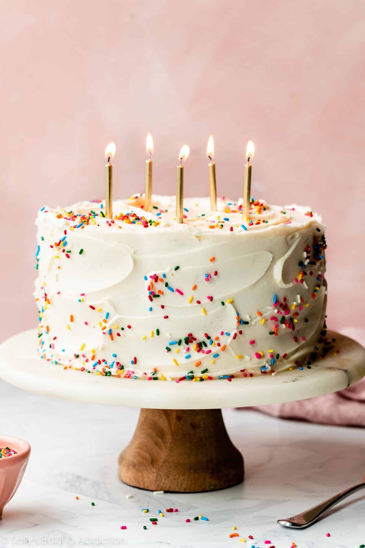 Vanilla birthday cake with sprinkles and candles