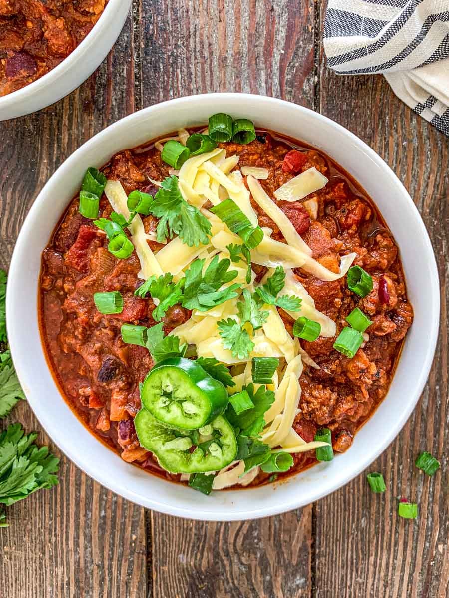 vibrant chili-loaded beef skillet with fresh toppings, overhead shot