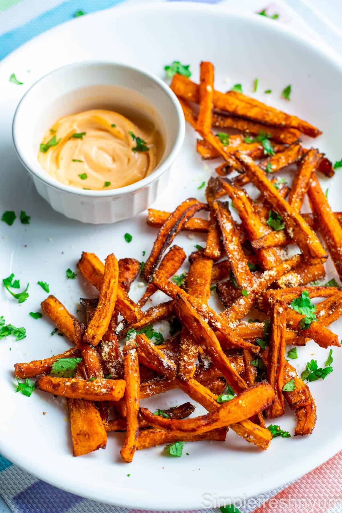curried carrot fries with yogurt dip, served in a rustic setting