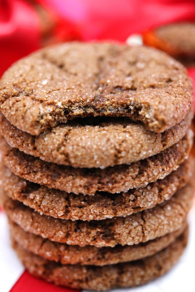 plate of freshly baked chewy dark molasses cookies with sugar crystals, warm kitchen setting