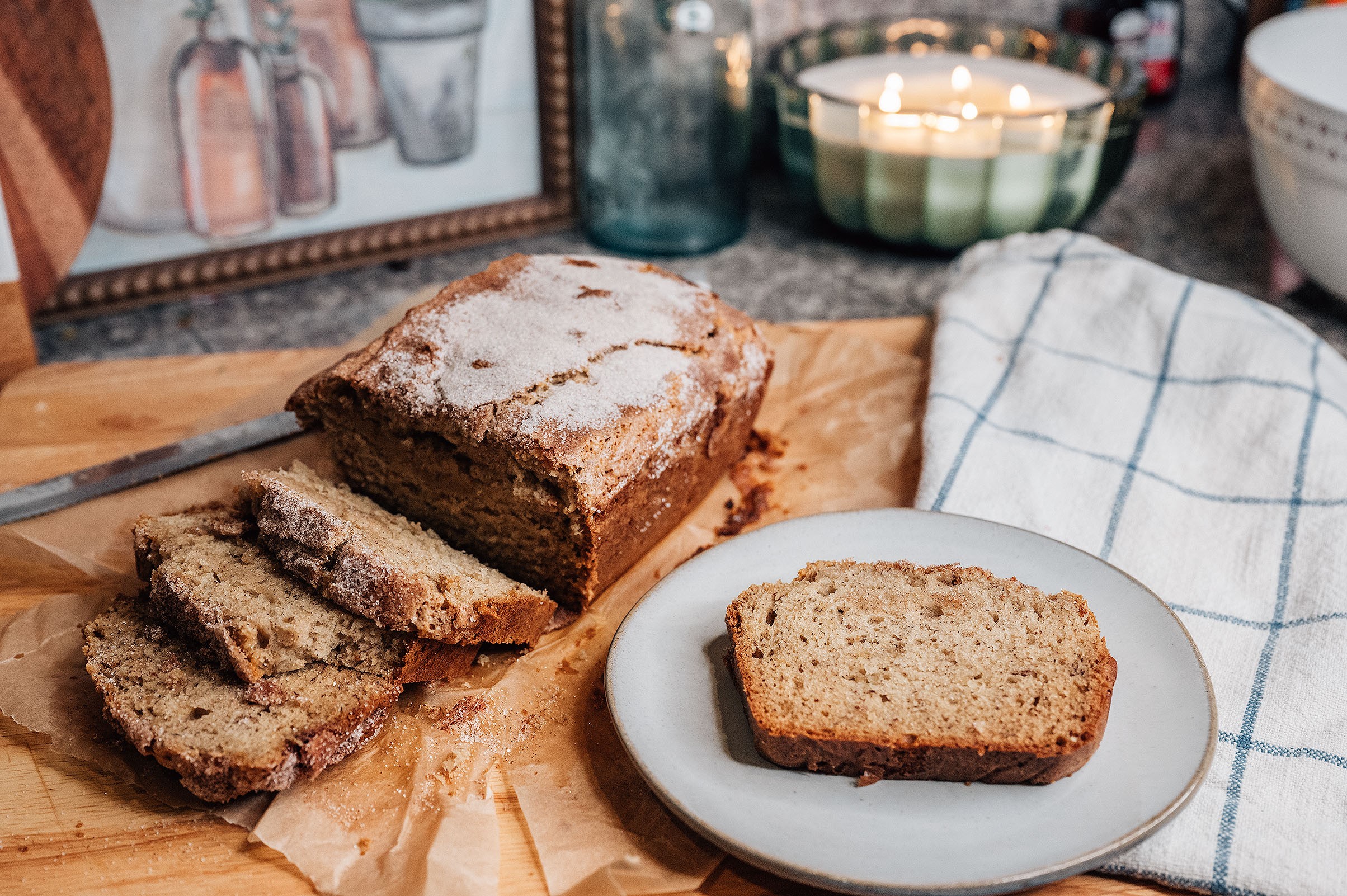 rustic holiday banana bread loaf with crackly sugar top, cozy kitchen setting