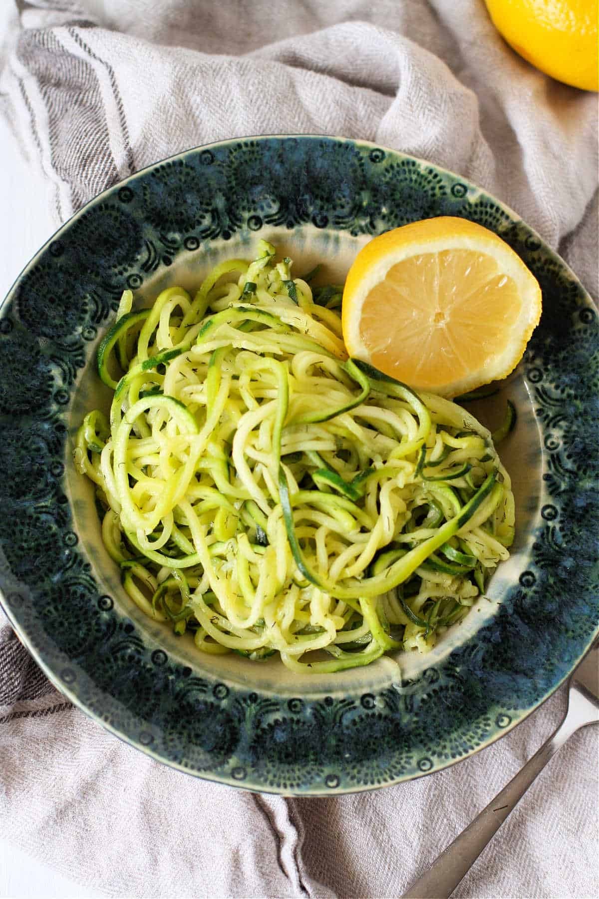 zucchini noodles with creamy lemon dill sauce in a bowl