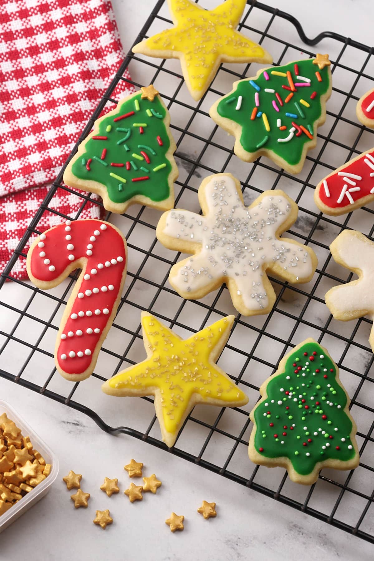 colorful star cut cookies on a cooling rack, glazed and decorated