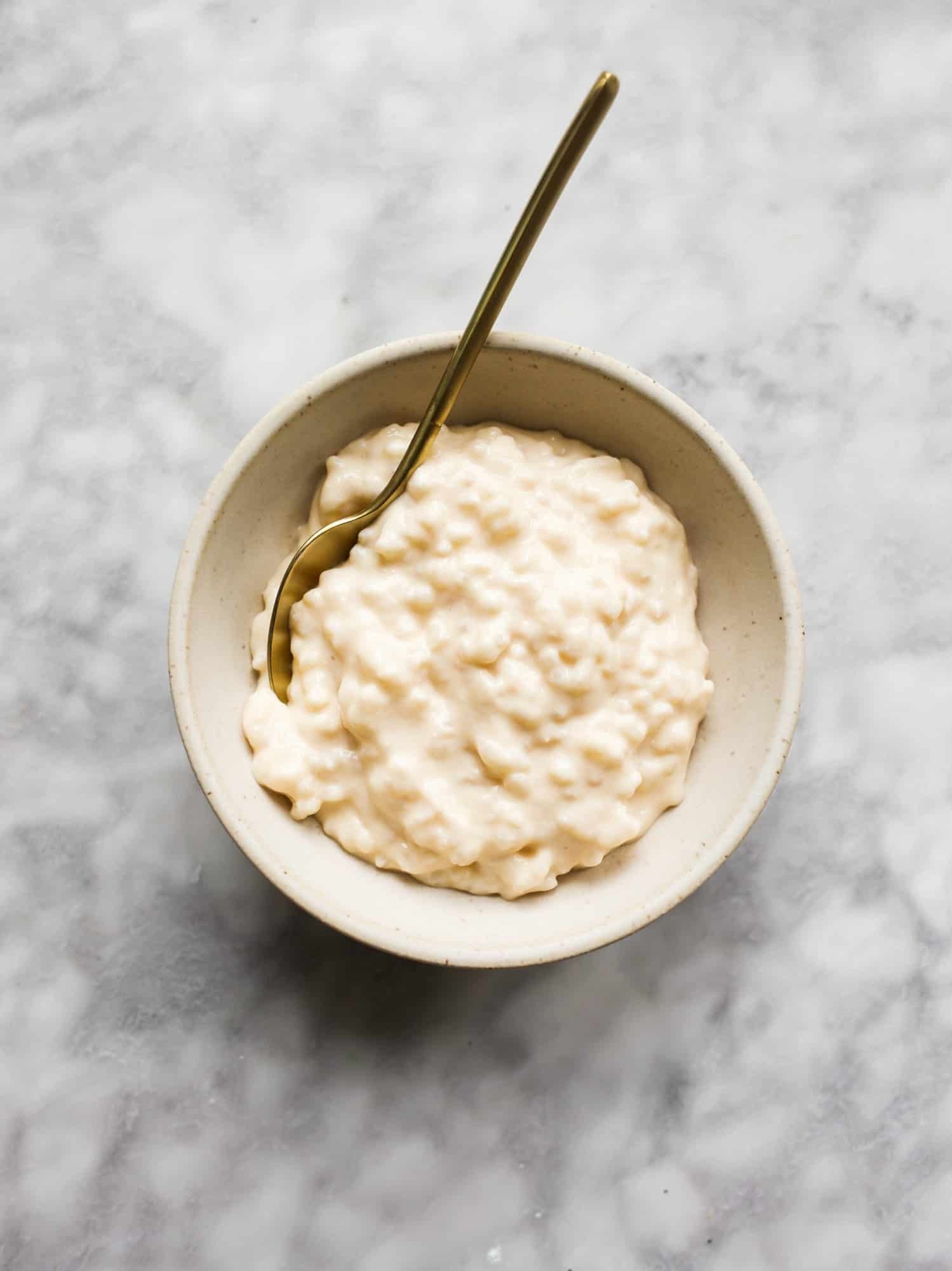 bowl of creamy rice milk with a sprinkle of pink salt