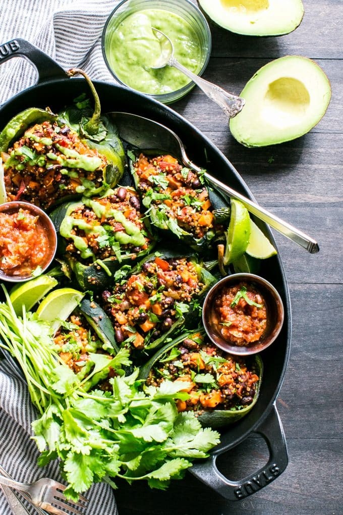 Quinoa and roasted vegetable stuffed poblano peppers on a rustic wooden table