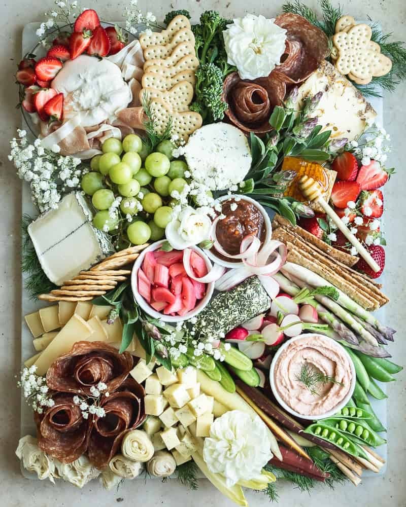 elegant charcuterie board with honeycomb and brie, rustic wooden background