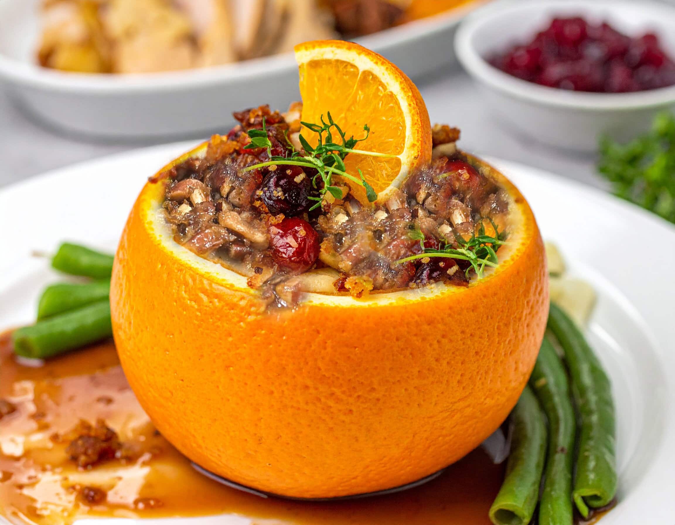 vibrant orange silky sweet potato bisque in a rustic bowl, garnished with fresh herbs, beside a warm fire