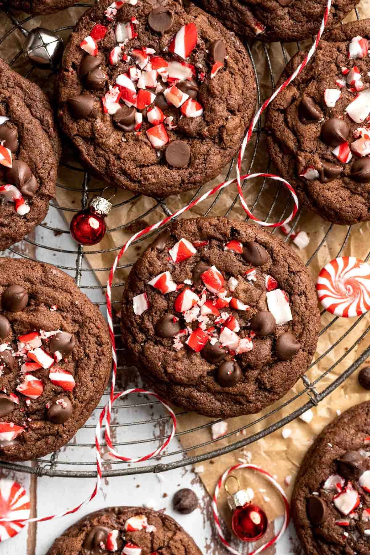 Festive cocoa peppermint cookies with crunchy edges on a cooling rack, holiday background with soft lighting