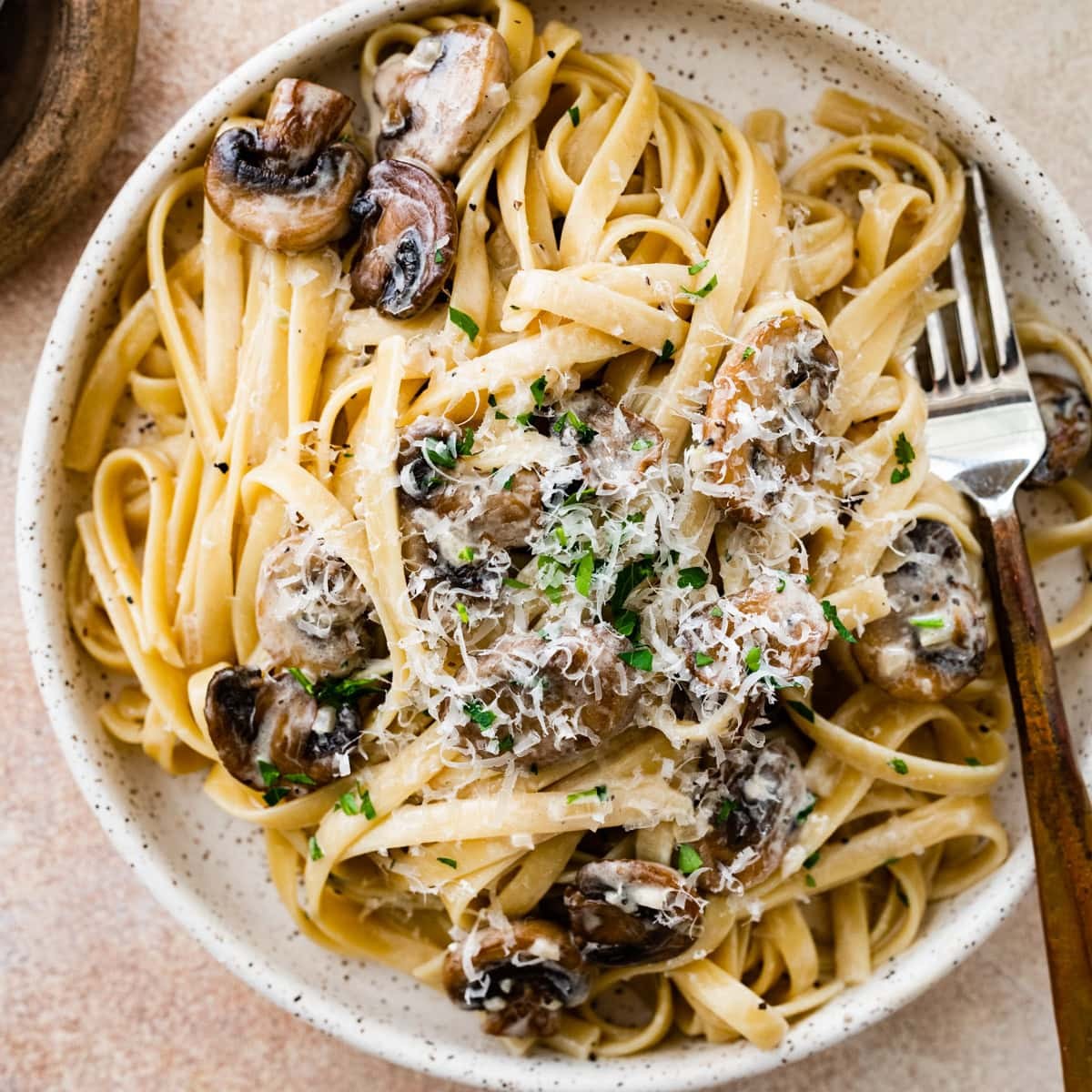 delicious creamy mushroom pasta with fresh parsley garnish, cozy kitchen lighting