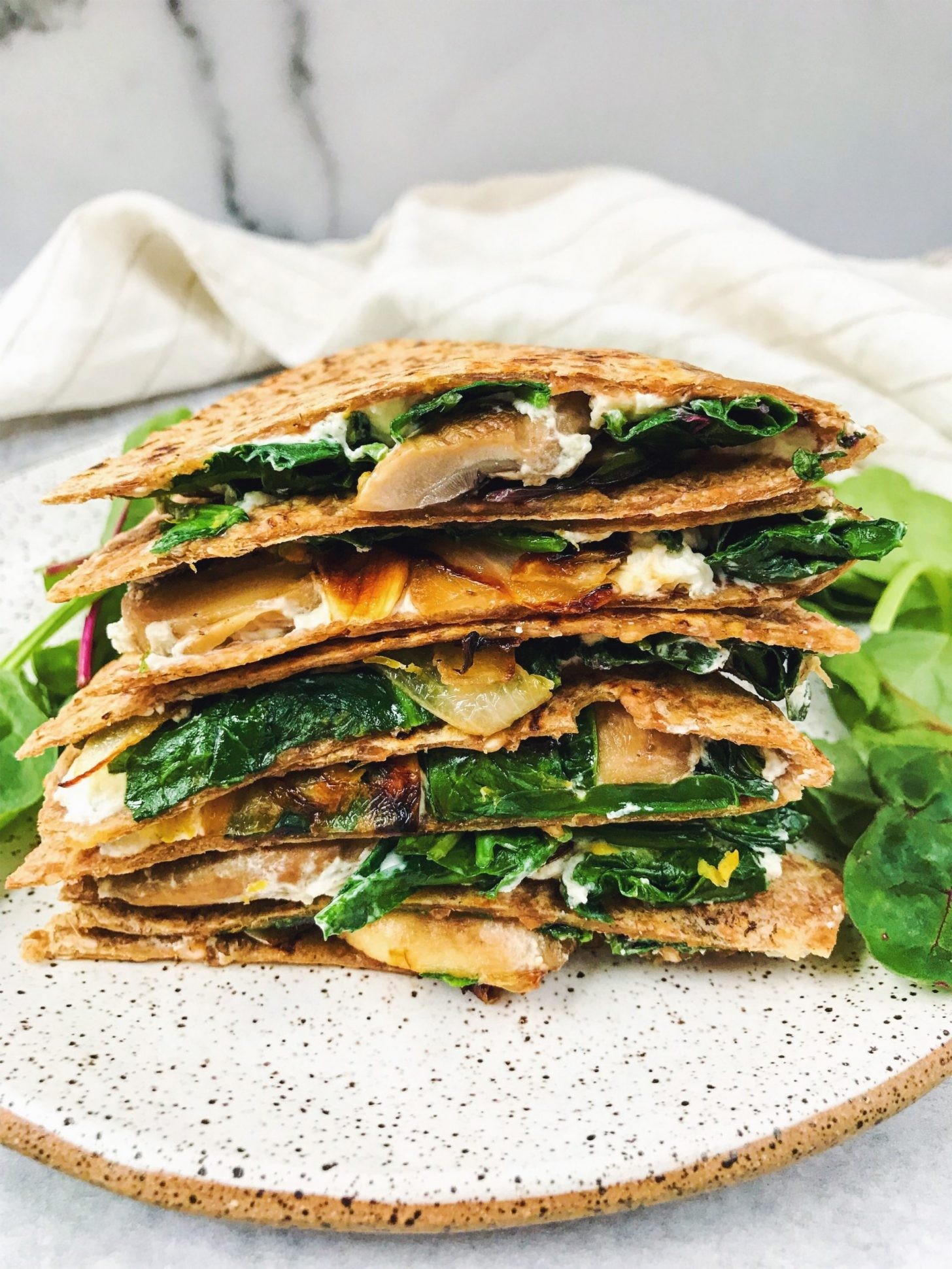 caramelized onion and goat cheese quesadillas being cooked on a skillet