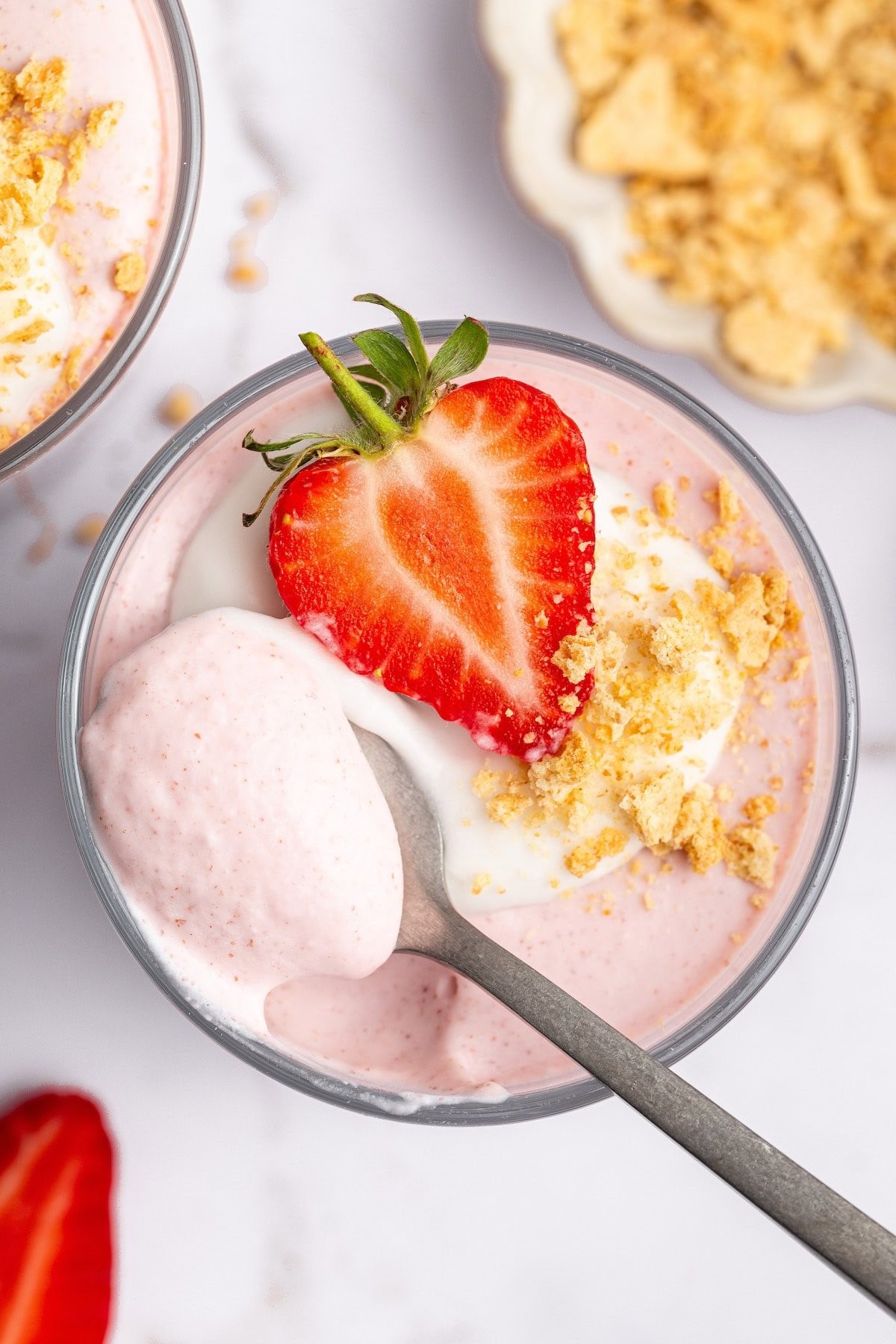 bowl of strawberry mousse cereal with fresh strawberries and whipped cream