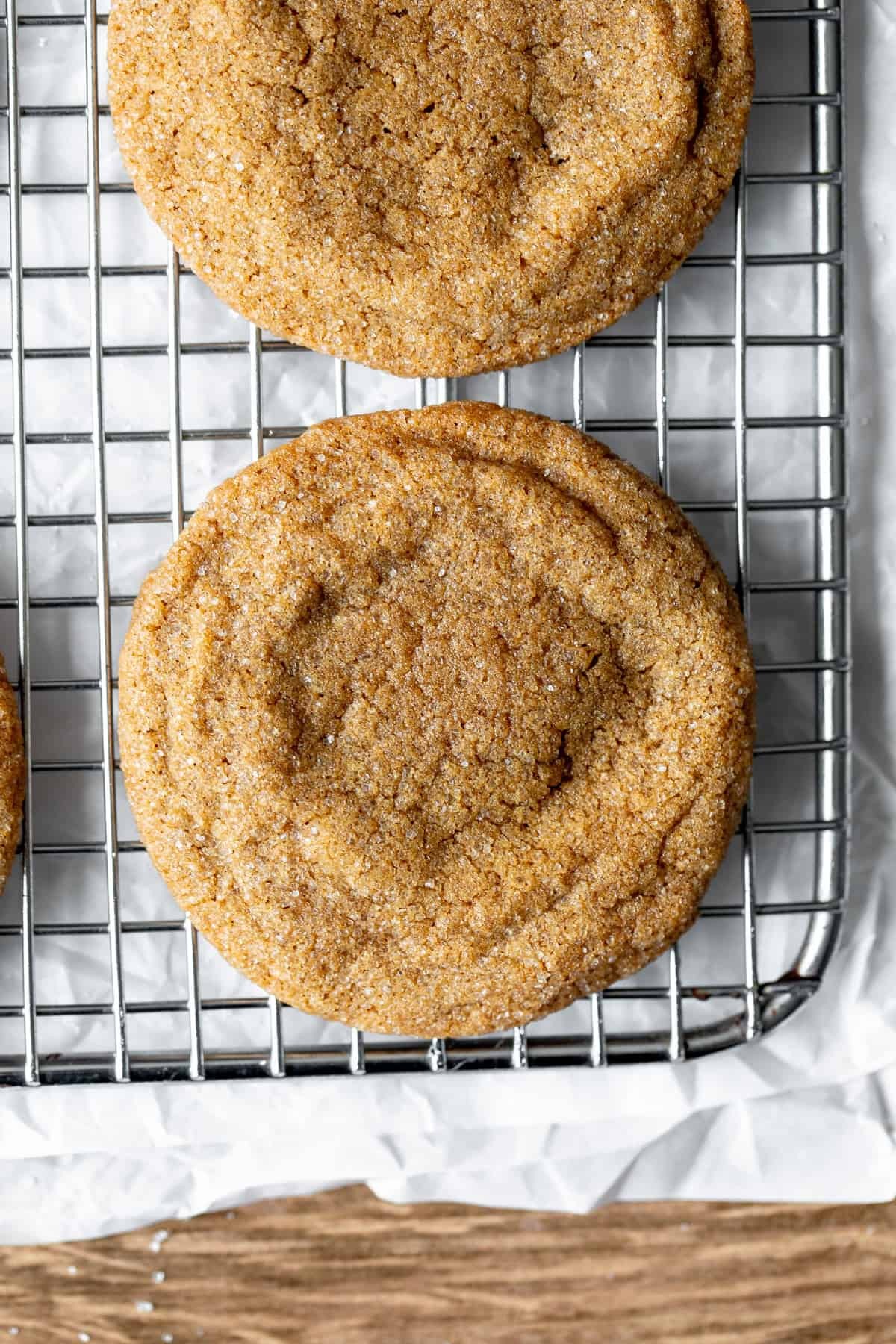 Golden brown sugar cookies with vanilla crumb topping cooling on a wire rack, sunlit kitchen