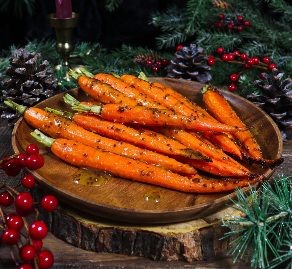 honey mustard roasted carrots on a wooden board
