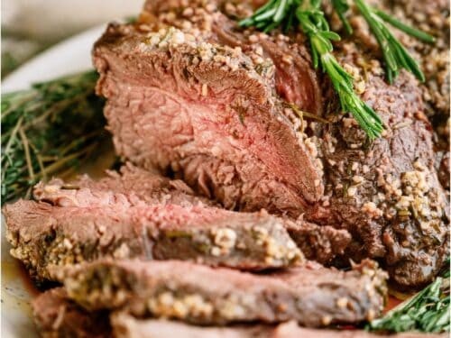 succulent garlic butter beef roast with herbs on a festive table