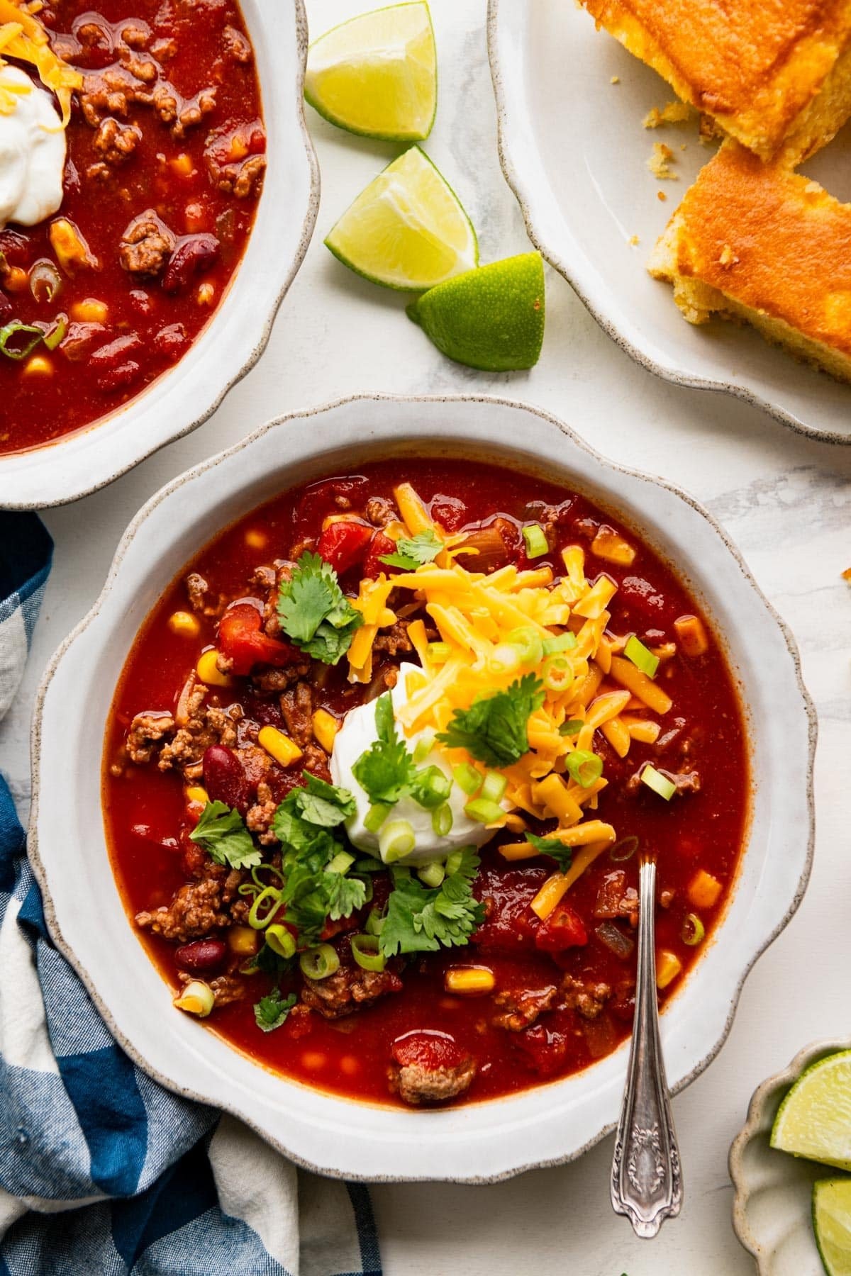 overhead shot of slow cooker chili in a bowl with toppings