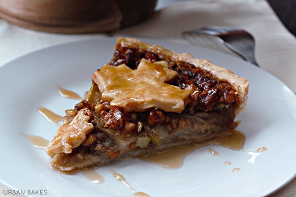 Maple walnut tart with crunchy top, golden brown, sliced, on a rustic wooden board, autumn theme